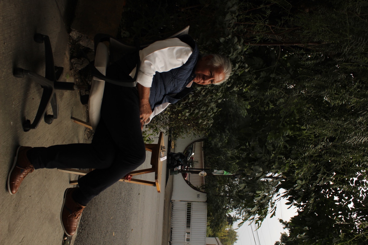 Relaxed outdoor street portrait under trees.